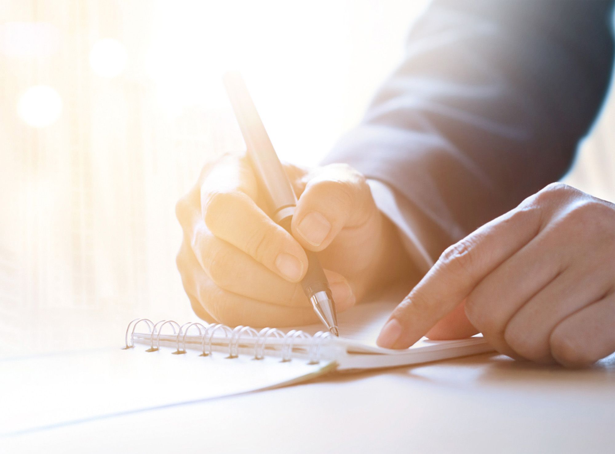 Man writing in a notepad
